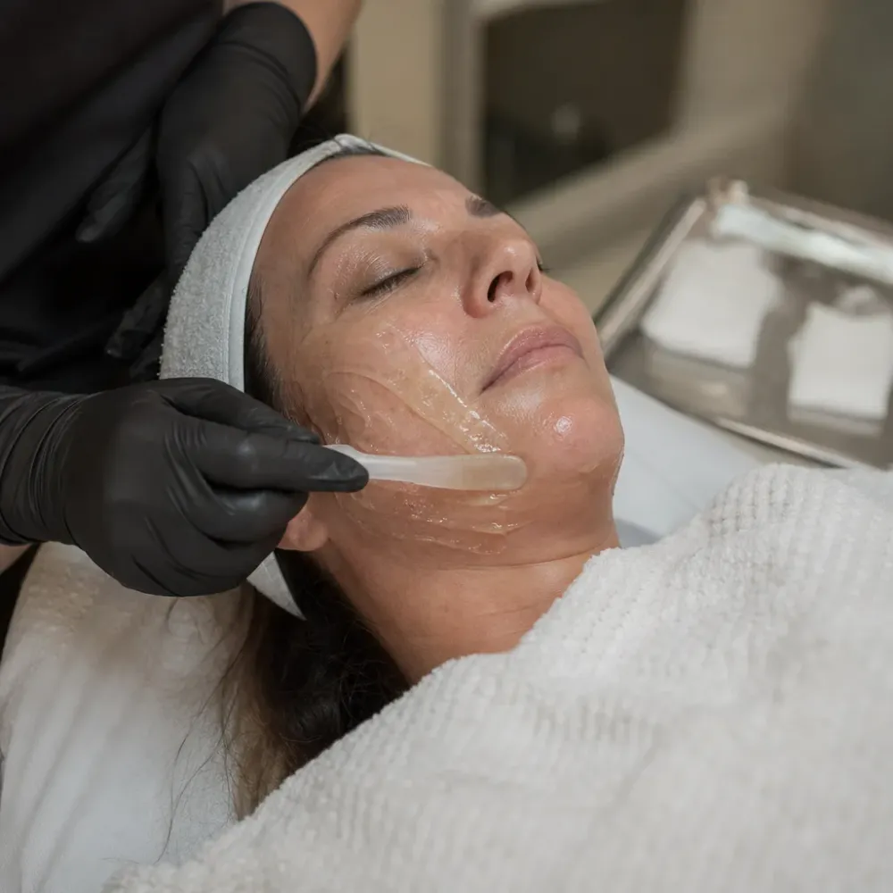 Applying PRF gel to patient's face during facial treatment near St. Johns Town Center Jacksonville